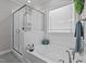 Bright bathroom featuring a soaking tub, separate shower, and a window for natural light at 118 Chanute Cir, Louisburg, NC 27549