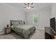 Comfortable bedroom with a queen-size bed, ceiling fan, and natural light from a window at 118 Chanute Cir, Louisburg, NC 27549