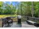 Outdoor living with a grill and seating on a deck overlooking a private backyard at 118 Chanute Cir, Louisburg, NC 27549