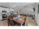 Open concept dining area with a wooden table that connects the kitchen and living room at 118 Chanute Cir, Louisburg, NC 27549