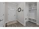 Welcoming entryway with wood flooring, a storage cubby and coat hooks, and a decorative front door at 118 Chanute Cir, Louisburg, NC 27549