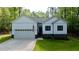 Inviting home with well-maintained lawn, attached garage, and patriotic American flag displayed at 118 Chanute Cir, Louisburg, NC 27549