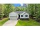 Charming single-Gathering home with a well-manicured lawn and attached two-car garage surrounded by beautiful trees at 118 Chanute Cir, Louisburg, NC 27549