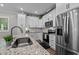 Bright kitchen with granite countertops, stainless steel appliances, and abundant white cabinetry at 118 Chanute Cir, Louisburg, NC 27549