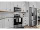 Updated kitchen with stainless steel appliances, granite countertops, and stylish white cabinetry at 118 Chanute Cir, Louisburg, NC 27549