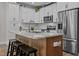 Modern kitchen with granite countertops, a kitchen island with seating, and stainless steel appliances at 118 Chanute Cir, Louisburg, NC 27549