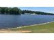 Scenic lake view featuring a serene body of water surrounded by lush trees, providing a tranquil and picturesque setting at 118 Chanute Cir, Louisburg, NC 27549