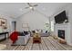 Open concept living room featuring a fireplace, neutral paint, a ceiling fan, and an open concept layout at 118 Chanute Cir, Louisburg, NC 27549
