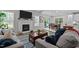 Bright living room featuring a fireplace, an open concept with kitchen, and an adjacent dining area at 118 Chanute Cir, Louisburg, NC 27549