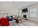 Inviting living room featuring a fireplace, neutral paint, and a ceiling fan perfect for entertaining at 118 Chanute Cir, Louisburg, NC 27549