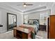 Bright main bedroom with a trey ceiling, a ceiling fan, and a large mirror at 118 Chanute Cir, Louisburg, NC 27549