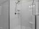 Modern glass-door shower with white subway tile and tiled floor in a well-lit bathroom at 118 Chanute Cir, Louisburg, NC 27549