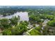 Stunning aerial view of a lakefront neighborhood featuring beautiful homes nestled among lush, mature trees at 118 Duncansby Ct, Cary, NC 27511