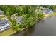 Aerial view showcasing a home on the lake surrounded by lush landscaping and neighboring properties at 118 Duncansby Ct, Cary, NC 27511