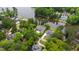 Aerial view of a house with lush green trees, a long driveway, and a body of water at 118 Duncansby Ct, Cary, NC 27511