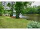 Well-manicured backyard with a bench offering peaceful views of the lake and surrounding greenery at 118 Duncansby Ct, Cary, NC 27511