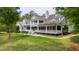 A lush backyard with grass and a patio area featuring a table and chairs at 118 Duncansby Ct, Cary, NC 27511