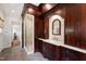 Elegant bathroom featuring dark wood cabinets, marble countertop, and glass-enclosed shower stall at 118 Duncansby Ct, Cary, NC 27511