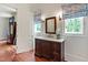 Charming bathroom with wood vanity, marble countertop, brass fixtures and natural light at 118 Duncansby Ct, Cary, NC 27511