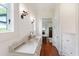 A stylish bathroom with marble countertops, wood floors, and decorative sconces and fixtures at 118 Duncansby Ct, Cary, NC 27511