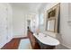 Charming bathroom featuring a clawfoot tub, wood floors, and elegant decor in a bright, airy space at 118 Duncansby Ct, Cary, NC 27511
