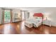 Large bedroom with wood floors, natural light, and a decorative bed and side tables at 118 Duncansby Ct, Cary, NC 27511