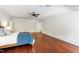 Bright bedroom featuring hardwood floors, ceiling fan, and ample space at 118 Duncansby Ct, Cary, NC 27511