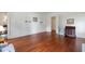 A spacious bedroom with wood floors, white walls, and natural light through an open doorway at 118 Duncansby Ct, Cary, NC 27511