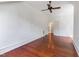 Spacious bedroom with hardwood floors, a ceiling fan, and a doorway at 118 Duncansby Ct, Cary, NC 27511