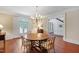 Dining room with hardwood floors, a round table, and a chandelier at 118 Duncansby Ct, Cary, NC 27511