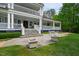 Charming home exterior with covered porches, stone steps, and lush landscaping at 118 Duncansby Ct, Cary, NC 27511