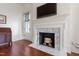 Elegant fireplace with white marble and black firebox in a well-lit room with hardwood floors at 118 Duncansby Ct, Cary, NC 27511