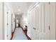 Bright hallway with hardwood floors and multiple doorways at 118 Duncansby Ct, Cary, NC 27511