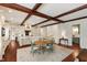 Spacious kitchen with exposed beams, white cabinets, a large island, and an adjacent dining area at 118 Duncansby Ct, Cary, NC 27511