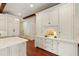 Elegant kitchen with extensive cabinetry and an adjacent entry to other rooms at 118 Duncansby Ct, Cary, NC 27511