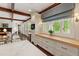 Bright kitchen featuring custom cabinets, wood beams, an expansive window, and butcher block countertops at 118 Duncansby Ct, Cary, NC 27511