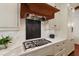 Close-up of gourmet kitchen, featuring a professional-grade stovetop and decorative hood at 118 Duncansby Ct, Cary, NC 27511