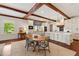 Bright kitchen featuring exposed beams, hardwood floors, and a large island with seating at 118 Duncansby Ct, Cary, NC 27511