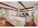 Large island with dual farmhouse sink, cooktop, and seating at 118 Duncansby Ct, Cary, NC 27511