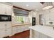 Close-up of the kitchen featuring built-in microwave and oven with adjacent window at 118 Duncansby Ct, Cary, NC 27511