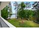 Enjoy serene lake views from the balcony surrounded by lush greenery and mature trees at 118 Duncansby Ct, Cary, NC 27511