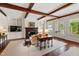 Bright living room with fireplace, exposed wood beams, and French doors to the exterior at 118 Duncansby Ct, Cary, NC 27511