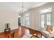 Living room with beautiful hardwood floors, a chandelier, and large windows at 118 Duncansby Ct, Cary, NC 27511