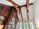 Lofted living room with wood beams, custom wood fireplace and mantle, and natural light at 118 Duncansby Ct, Cary, NC 27511
