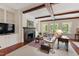 Cozy living room with exposed wood beams, fireplace, and ample natural light at 118 Duncansby Ct, Cary, NC 27511