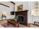 Living room features a wooden fireplace, built-in cabinets, and exposed wood beams at 118 Duncansby Ct, Cary, NC 27511