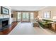 Inviting living room featuring a fireplace, built-in cabinets, and french doors at 118 Duncansby Ct, Cary, NC 27511