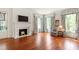 Living room featuring a marble fireplace, hardwood floors, and natural light at 118 Duncansby Ct, Cary, NC 27511