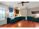 Spacious mud room with green cabinets, farmhouse sink, wood floors and blue and white valences at 118 Duncansby Ct, Cary, NC 27511