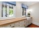 Mud room featuring a long countertop, farmhouse sink, blue and white valences and natural light at 118 Duncansby Ct, Cary, NC 27511